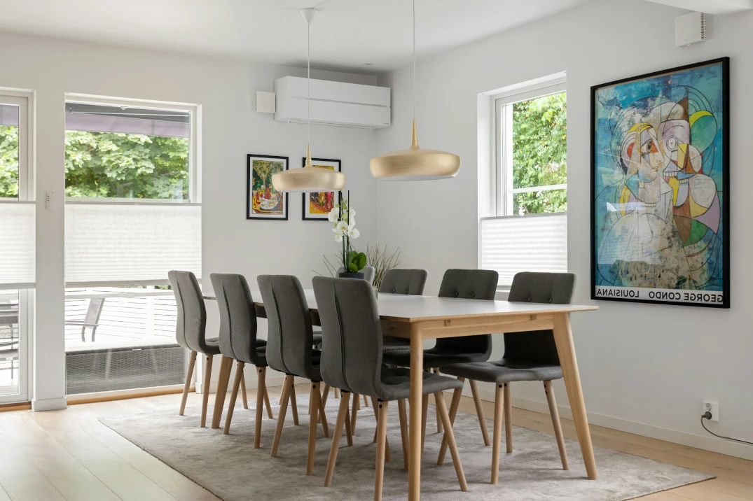 Custom white cellular shades on large dining room windows, providing softly filtered natural light, privacy, and energy-efficient