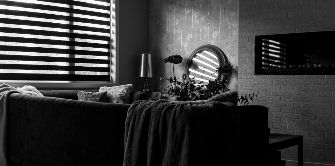 Custom black and white banded shades featuring alternating sheer and opaque fabric panels, providing adjustable light control, privacy, and modern living room style.