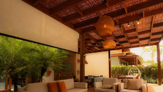 Custom exterior roller shades installed on a covered outdoor patio, providing sun protection, reduced glare, and enhanced comfort for a stylish outdoor living space.