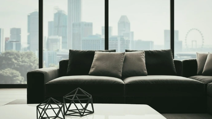 Solar roller shades on floor-to-ceiling living room windows, reducing glare and filtering sunlight while preserving panoramic city views.